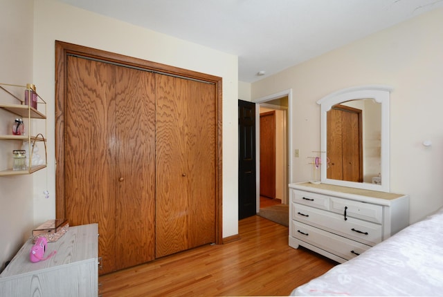 bedroom featuring a closet and light wood finished floors