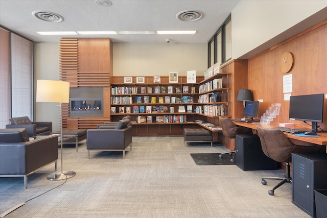 carpeted office with wooden walls and visible vents