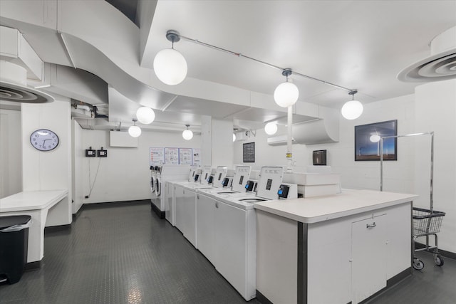 community laundry room with washing machine and clothes dryer