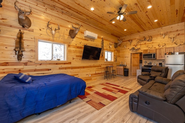 bedroom featuring light wood-style floors, wood ceiling, freestanding refrigerator, wood walls, and a wall mounted AC