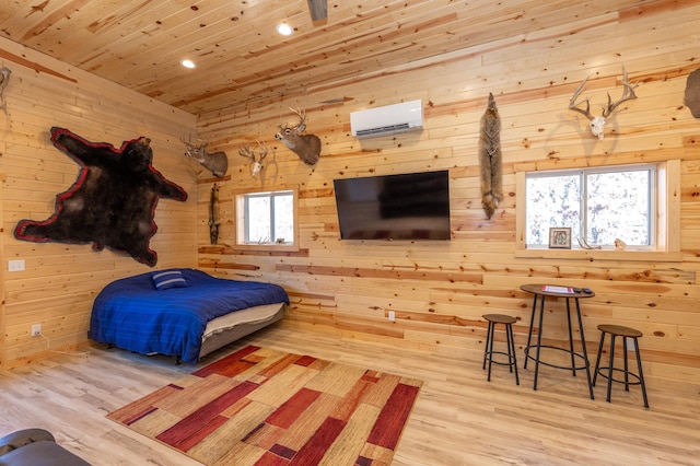 bedroom featuring an AC wall unit, wooden ceiling, wood finished floors, and wooden walls