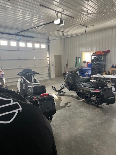 garage featuring metal wall and a garage door opener