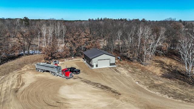 birds eye view of property with a wooded view