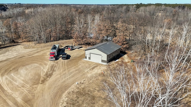 drone / aerial view with a wooded view