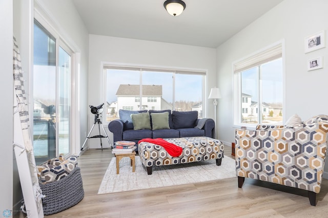 living room with baseboards and wood finished floors