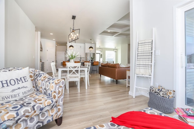 living area featuring a notable chandelier, recessed lighting, wood finished floors, coffered ceiling, and beamed ceiling