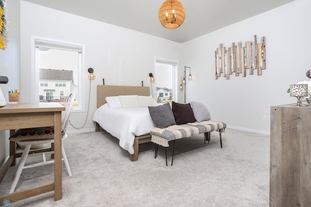 carpeted bedroom featuring baseboards