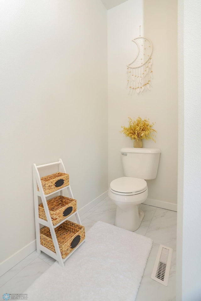 bathroom with marble finish floor, baseboards, and visible vents