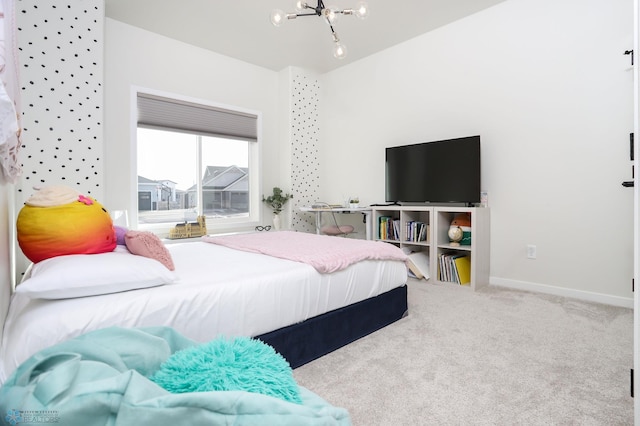 bedroom featuring baseboards, carpet floors, and an inviting chandelier