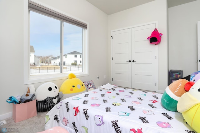 carpeted bedroom with a closet