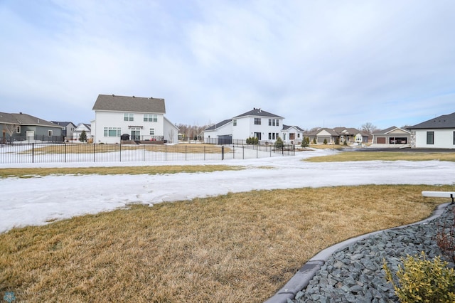 view of yard featuring fence and a residential view