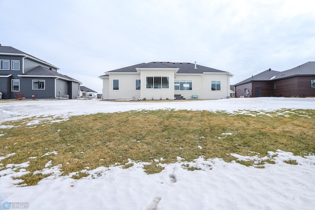 view of snow covered back of property