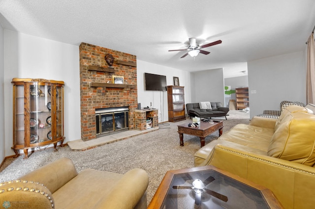 carpeted living area with a brick fireplace, ceiling fan, and a textured ceiling