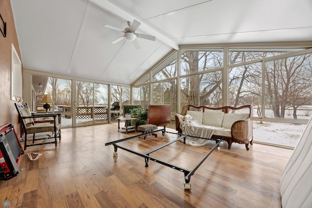 sunroom / solarium featuring vaulted ceiling with beams and a ceiling fan