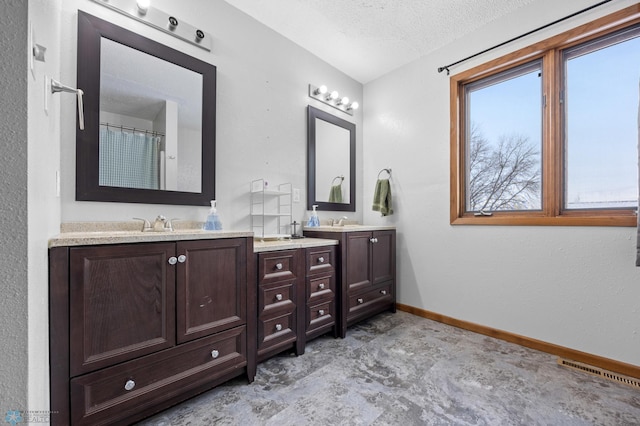 full bathroom featuring baseboards, visible vents, a textured ceiling, and vanity