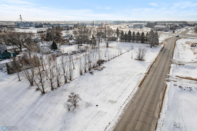 snowy aerial view with a residential view