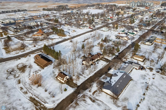 snowy aerial view featuring a residential view