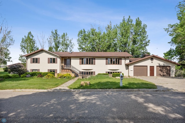 289 2nd St SW, Forman, ND 58032 - view of front of home featuring concrete driveway, a front lawn, and an attached garage