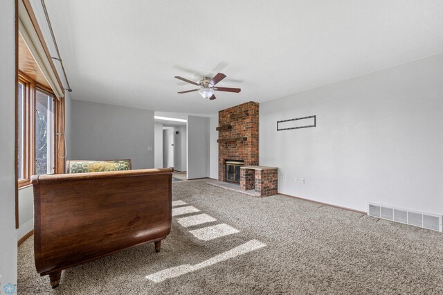 289 2nd St SW, Forman, ND 58032 - carpeted living area with a ceiling fan, a brick fireplace, and baseboards