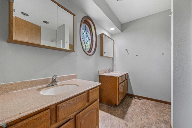 289 2nd St SW, Forman, ND 58032 - bathroom with two vanities and baseboards
