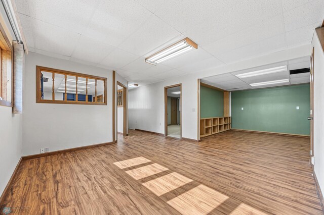 289 2nd St SW, Forman, ND 58032 - empty room featuring wood finished floors, a paneled ceiling, and baseboards