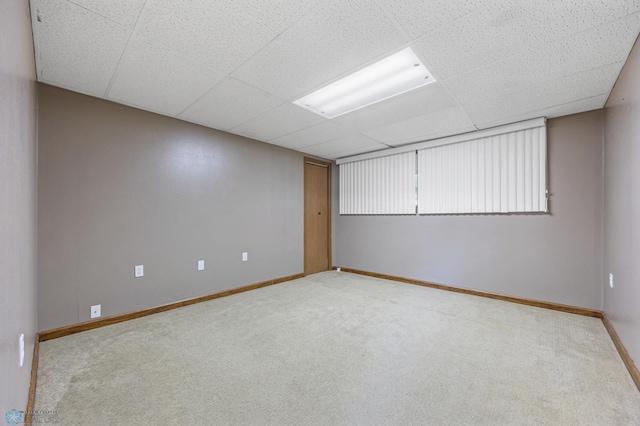 289 2nd St SW, Forman, ND 58032 - carpeted empty room with baseboards and a paneled ceiling