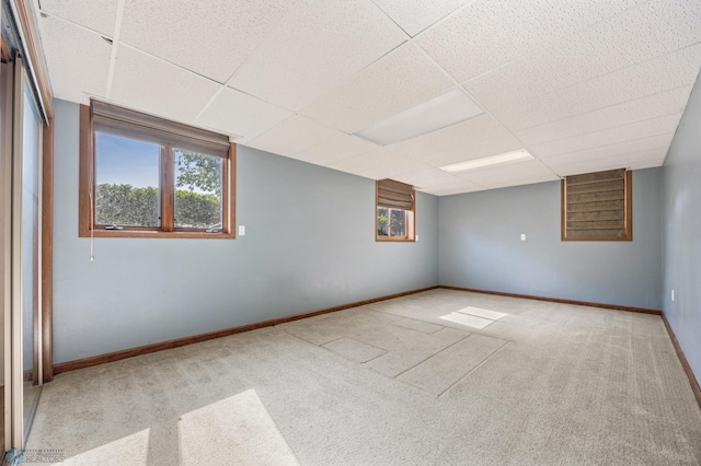 289 2nd St SW, Forman, ND 58032 - empty room featuring carpet flooring, a paneled ceiling, and baseboards