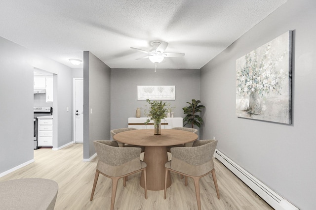 dining space with a textured ceiling, a ceiling fan, baseboards, light wood-style floors, and baseboard heating