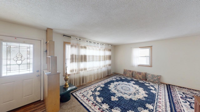 entryway with a textured ceiling