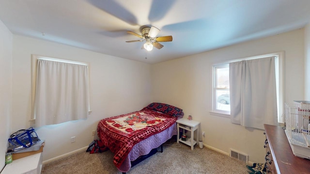 bedroom featuring carpet flooring, baseboards, visible vents, and ceiling fan