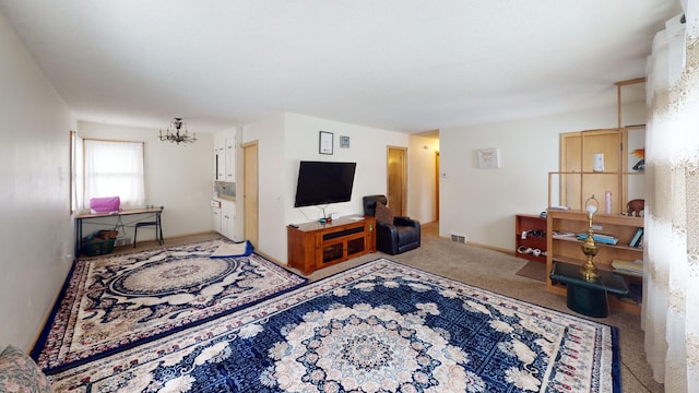 carpeted living room with a notable chandelier and visible vents