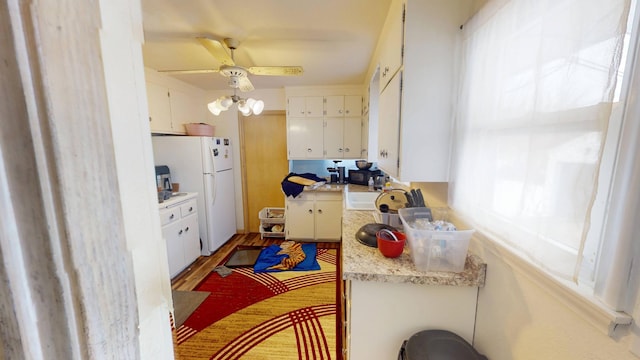 kitchen with white cabinetry, a ceiling fan, light countertops, and freestanding refrigerator