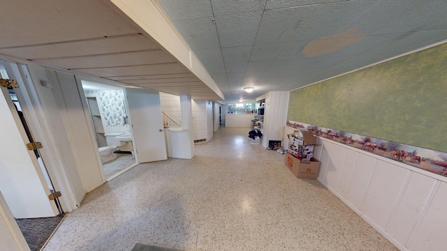 hallway featuring speckled floor