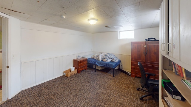 home office featuring visible vents and a wainscoted wall