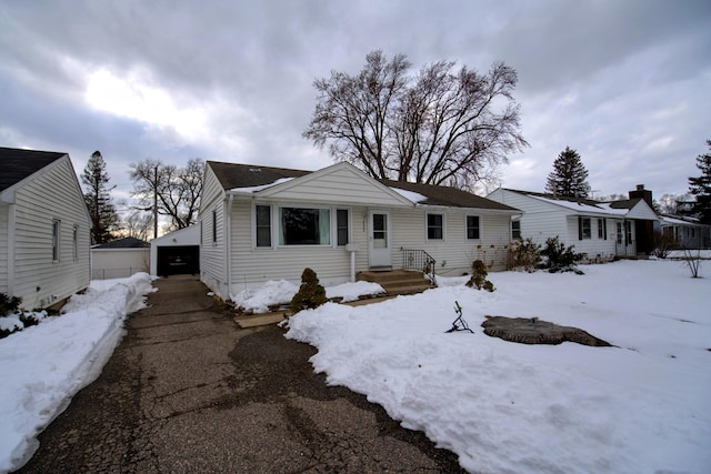 view of front facade with a garage and an outdoor structure