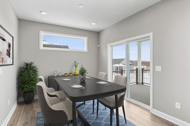 dining room with light wood-style floors and baseboards