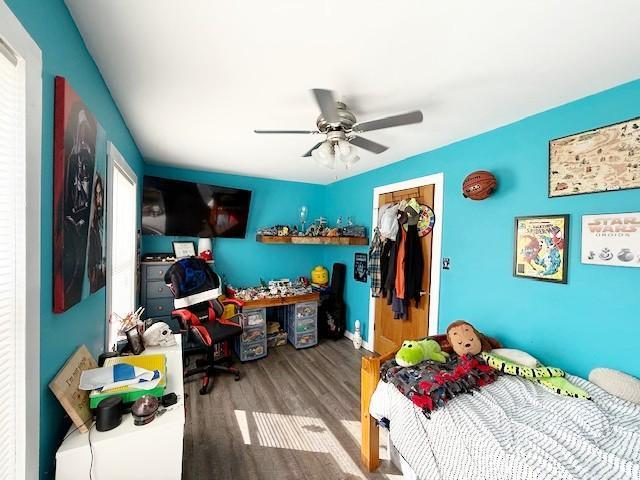 bedroom with a ceiling fan, a closet, and wood finished floors