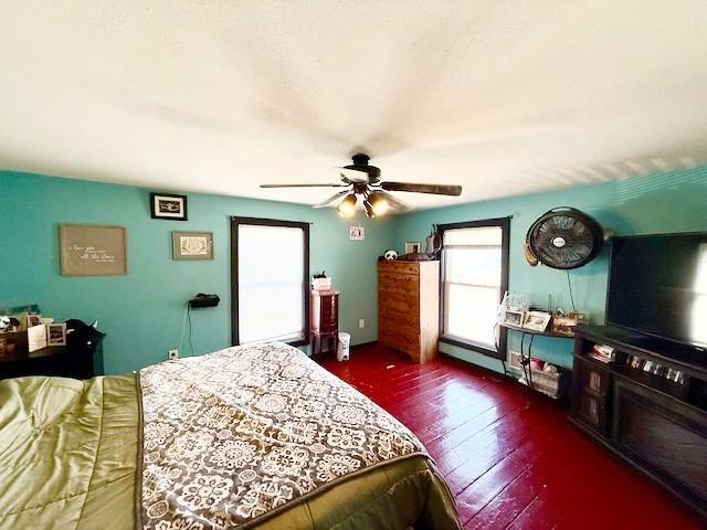 bedroom with ceiling fan and hardwood / wood-style floors