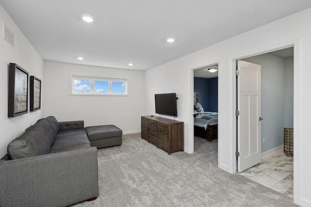 carpeted living area with recessed lighting, visible vents, and baseboards