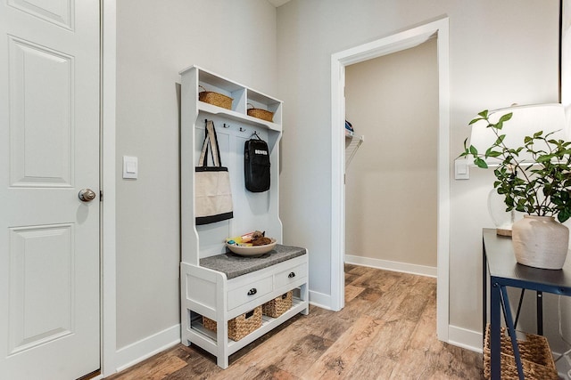 mudroom with wood finished floors and baseboards