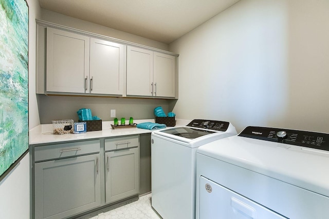 laundry room with cabinet space and washer and clothes dryer