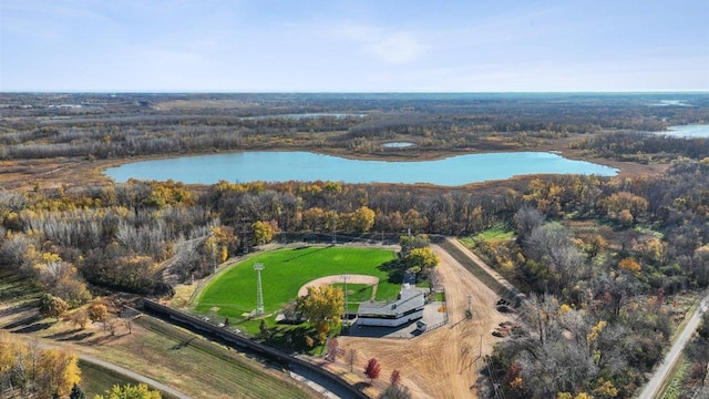 drone / aerial view with a water view and a forest view