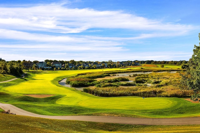 view of property's community with a lawn and golf course view