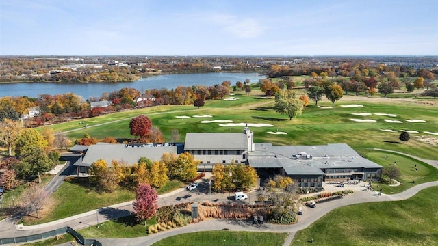 birds eye view of property with view of golf course and a water view