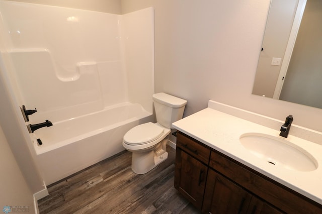 full bath featuring toilet, shower / bathing tub combination, wood finished floors, and vanity