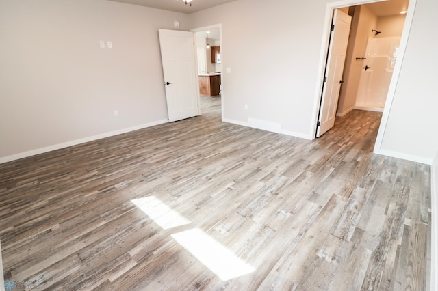 unfurnished bedroom with baseboards and wood finished floors