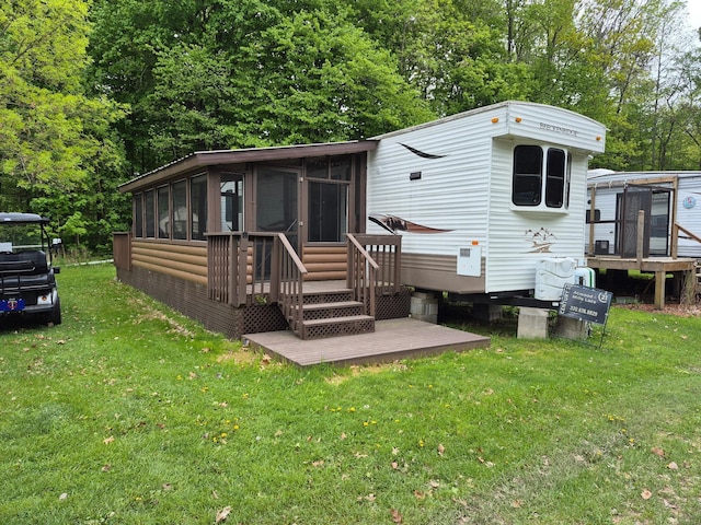 13087 Twilight Rd # 15, Onamia, MN 56359 - back of property featuring a sunroom, a yard, and entry steps