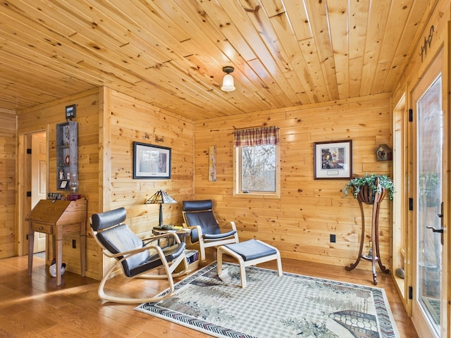 living area featuring wood-type flooring and wooden ceiling