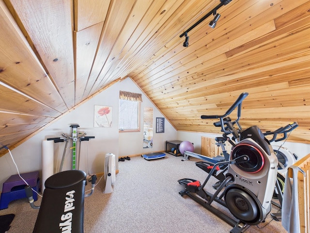 workout area with lofted ceiling, rail lighting, wood ceiling, and carpet