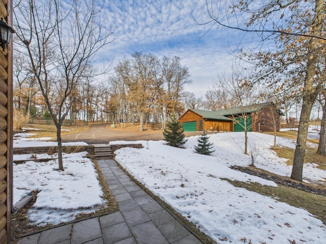 yard layered in snow with a garage